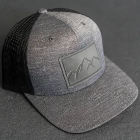 Leather Patch Performance Style Trucker Hat - Mountain Range Stamp