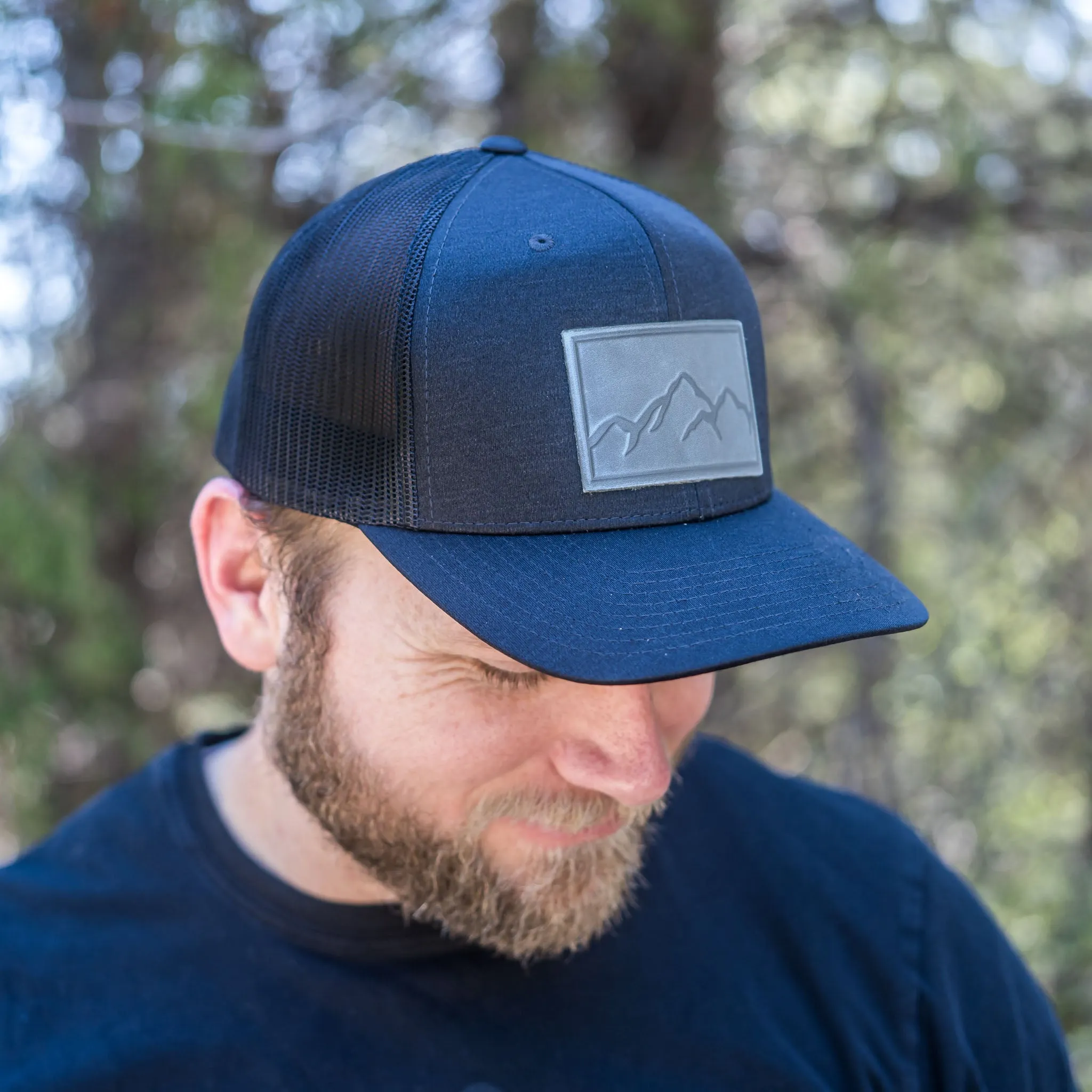 Leather Patch Performance Style Trucker Hat - Mountain Range Stamp